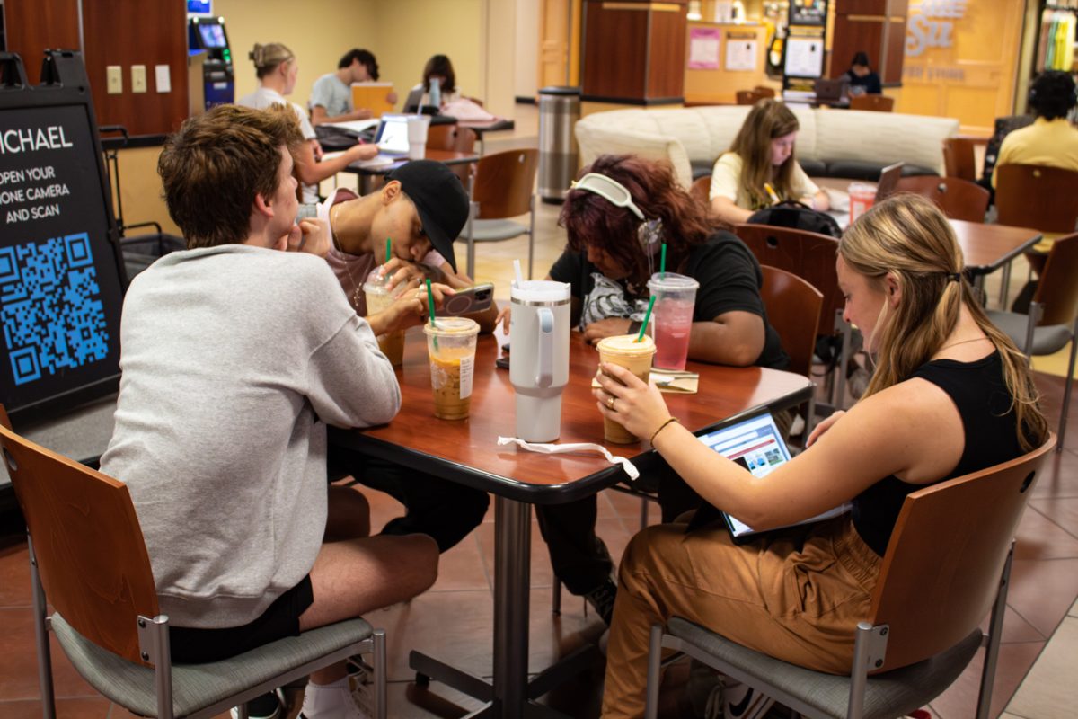Conner Morris, Javon Miller, Lourdes Portillo, and Laney Alexander listen to performer J. Michael during the Monday Melodies event on Aug. 28. The group of freshmen sat in front of the stage in the Starbucks lounge.