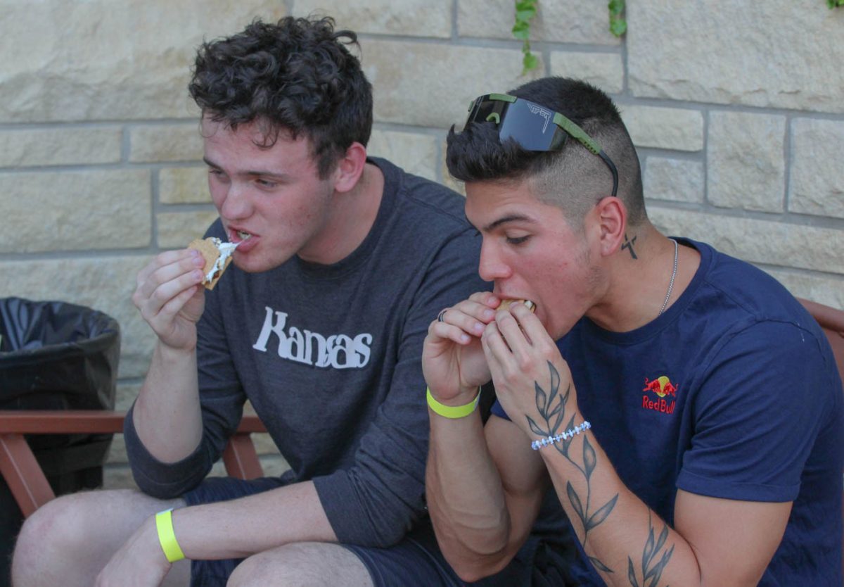 Two students enjoy smores provided at the Shocker Rowing Smores and Oars event on Aug. 30. This was the fifth year the Shocker Rowing team has put on this event.