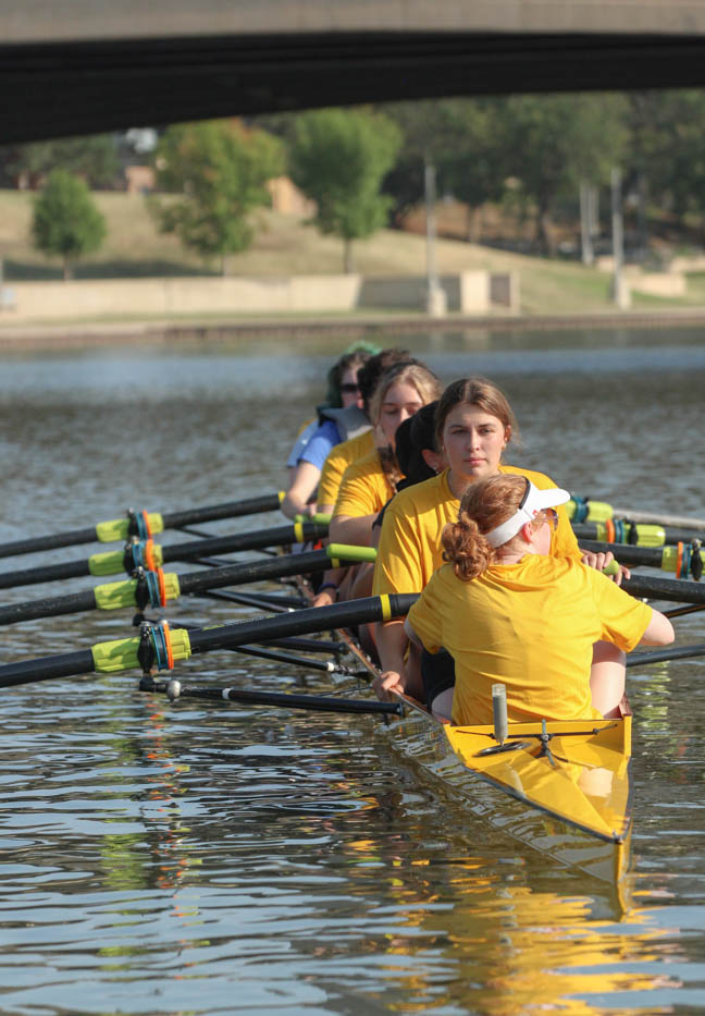 The female Shocker Rowing team guides Wichita State students and Wichita citizens in their competition boats. Both male and female rowing teams were present at the Smores and Oars event.