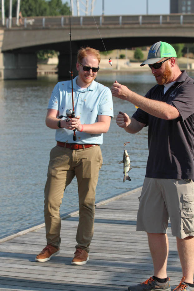 Nathan Lewis catches the first fish of the evening at the Shocker Rowing Smores and Oars event on Aug. 30. Lewis said he came to hang out with the WSU community. I think it is a great opportunity to improve my opinion of Wichita and what it has to offer, Lewis said.