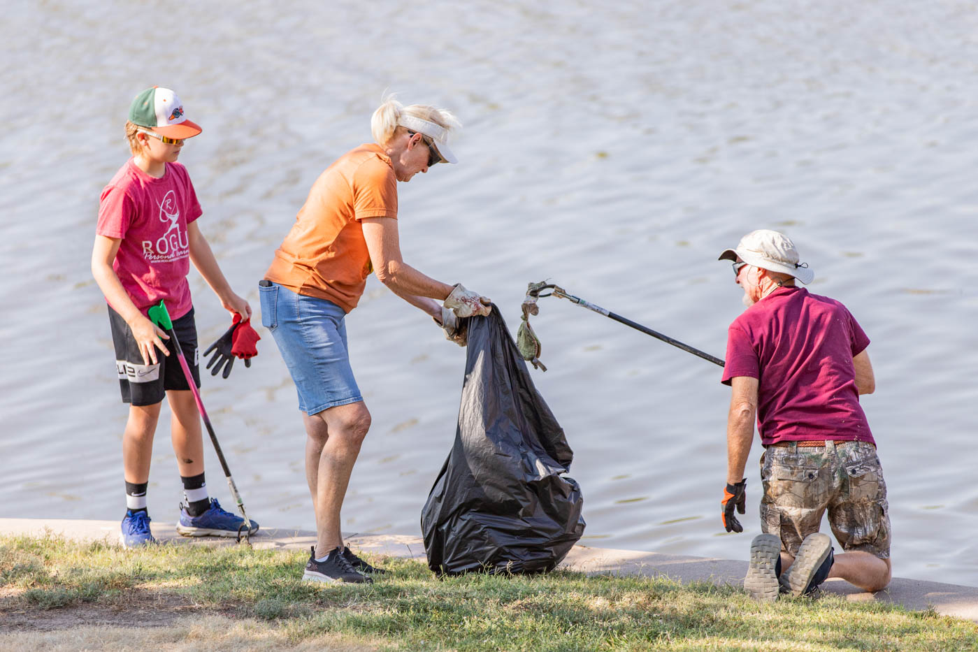 Debbie and Jim Sims pick up trash from the River on Sept. 9 during the Wichita Clean Streams event. The Sims attended the event with their grandson, after seeing an ad through the Wichita Windsurge.