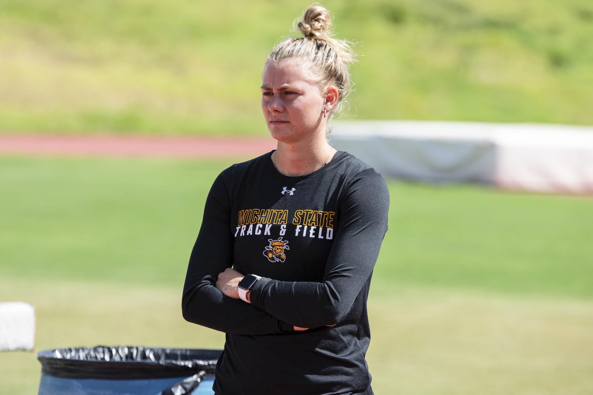 Aliyah Welters, an assistant coach for Wichita States track and field team, watches runners at the Sept. 12 practice. Welters helps coach pole vaulters on the team.