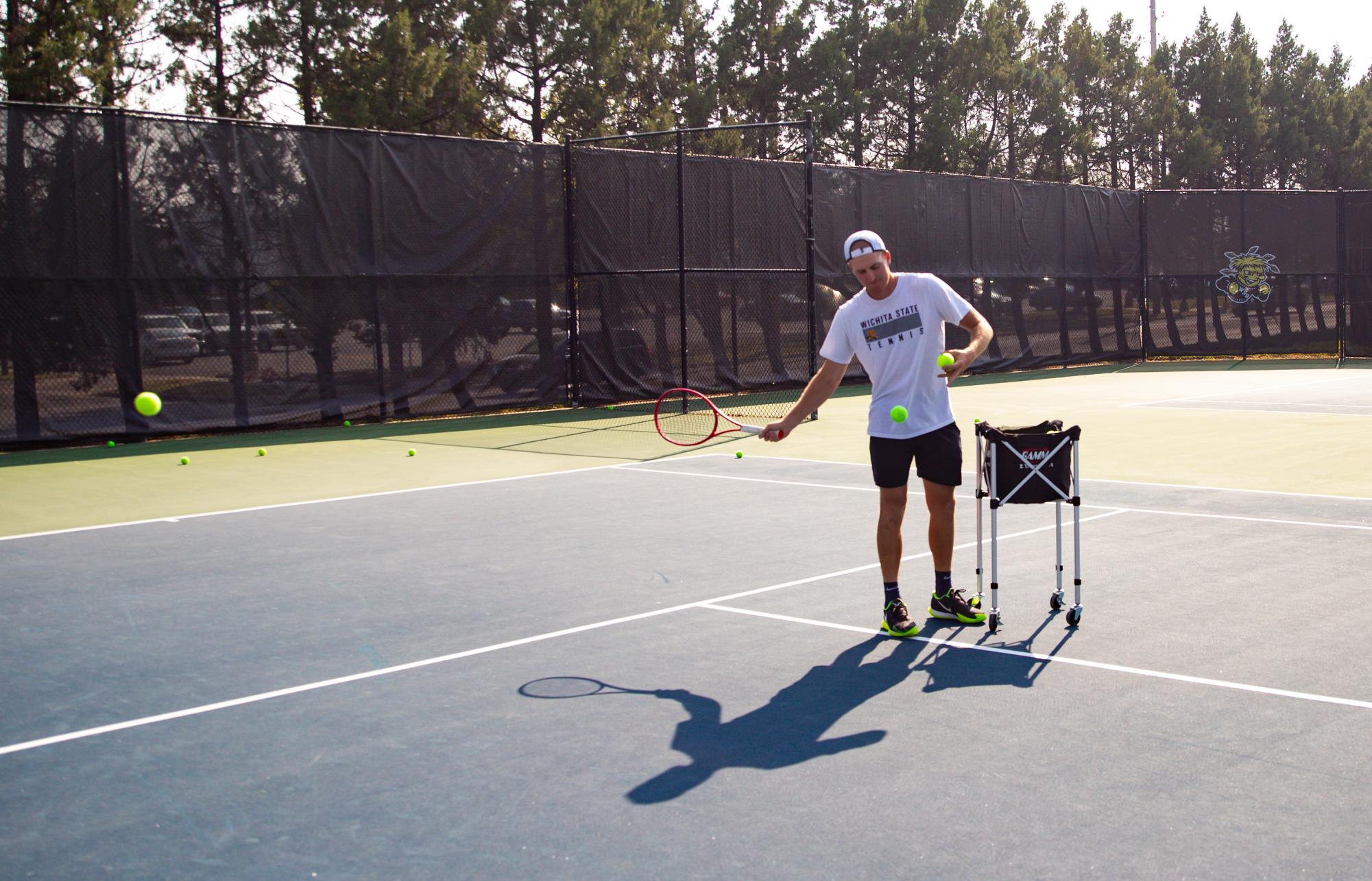 Chad Kissell, the new assistant tennis coach, feeding balls on Sept. 7.