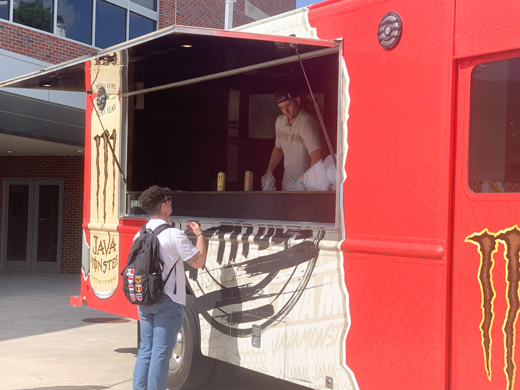 A student receives a free Monster outside of the RSC. Free Java Monsters were given to any participants passed by the truck.