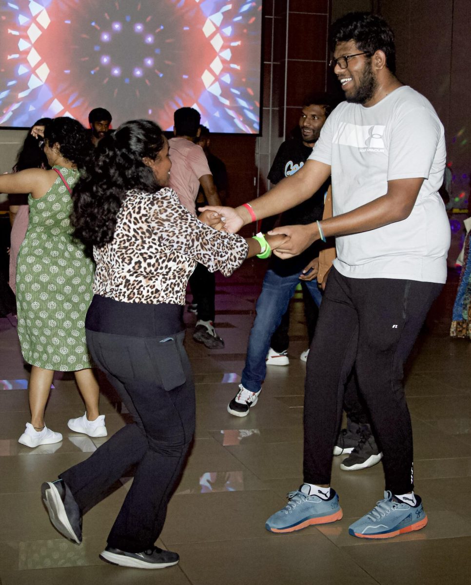 Two students dance together at  Bollywood Night. The event was held by the Association of Hindu Students In America on Sept. 2.