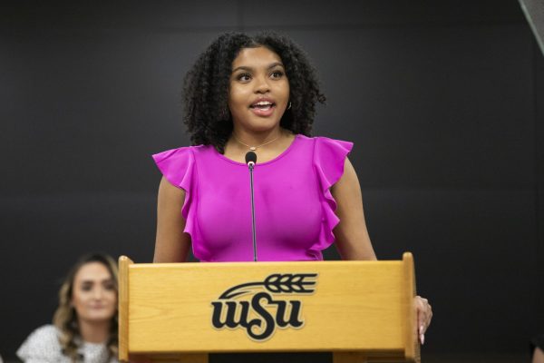 Student Body President Iris Okere speaks to various people at Wichita State at the State of the Student Body on Sept. 6.