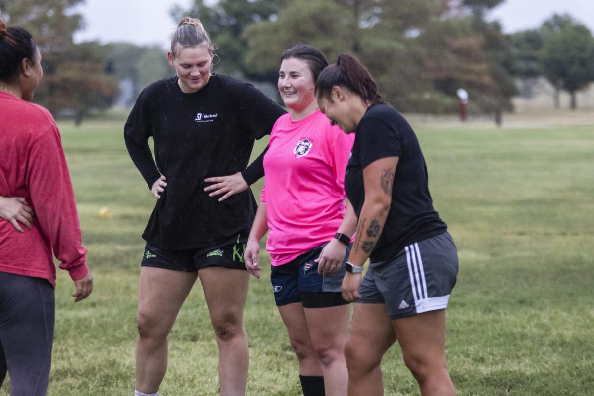 Wichita Valkyries Secretary Abbie Winchester and Captain Jenna DeRoo chat with Ave Liaiga during a brief break at the Sept. 11 practice. Winchester, DeRoo and Liaiga are all returning rugby players who offer guidance to new players.