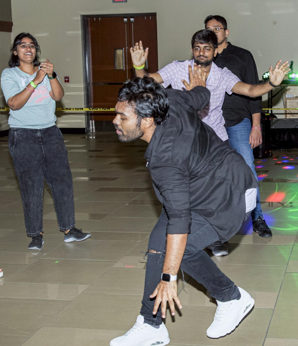 Wichita State students get funky in the middle of the dancefloor, dancing to classic hits played for Bollywood Night on Sept. 2.