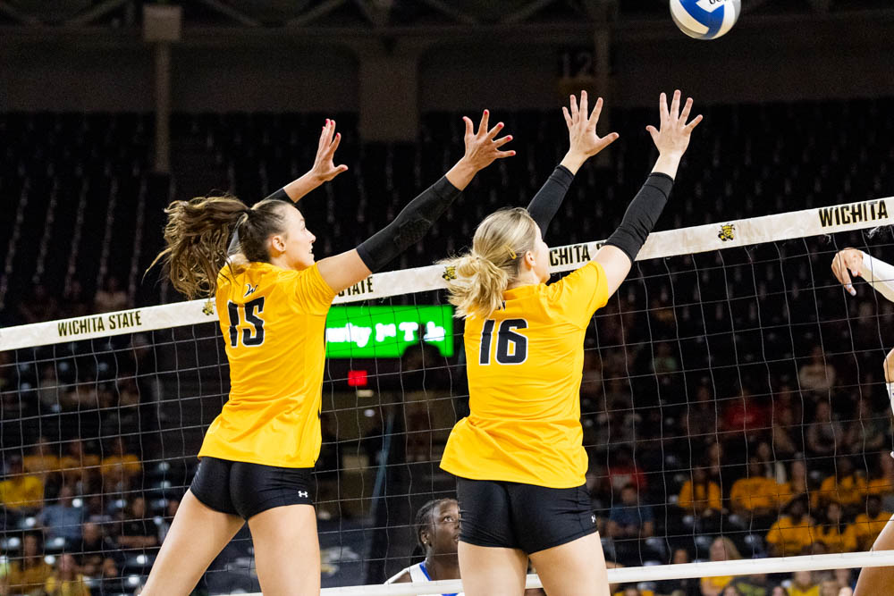 Blocker Morgan Stout and setter Izzi Strand block against Kansas on Sept. 7 at Charles Koch Arena for Yellow Out night. Strand had a total of 36 assists during the game.