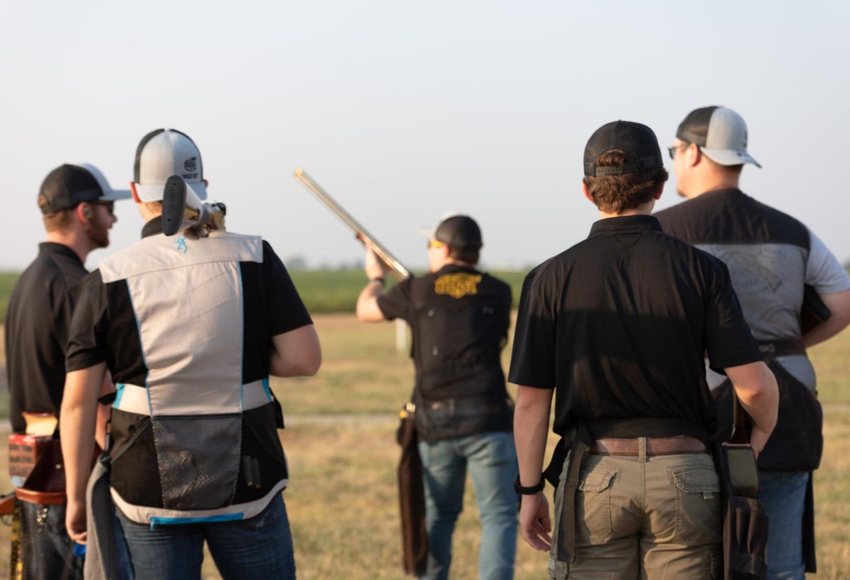 Shooting Team members watch the teams president, Tyler Bayliff, shoot at clay pigeons during practice on Sept. 6.
