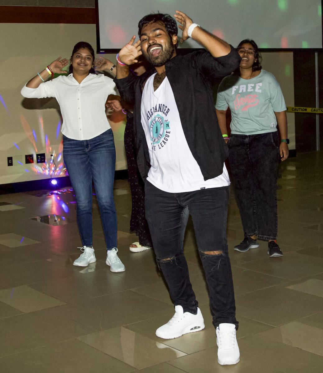 Wichita State students get funky in the middle of the dancefloor, dancing to classic hits played for Bollywood Night on Sept. 2.