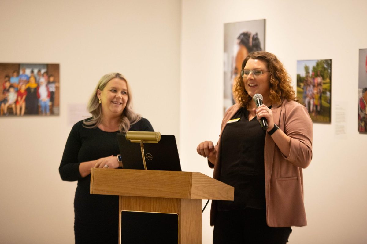 Bree Ireton, the program manager of homeless services, and Greer Cowley, the director of donor relations and community engagement, assist in the Humankind presentation.