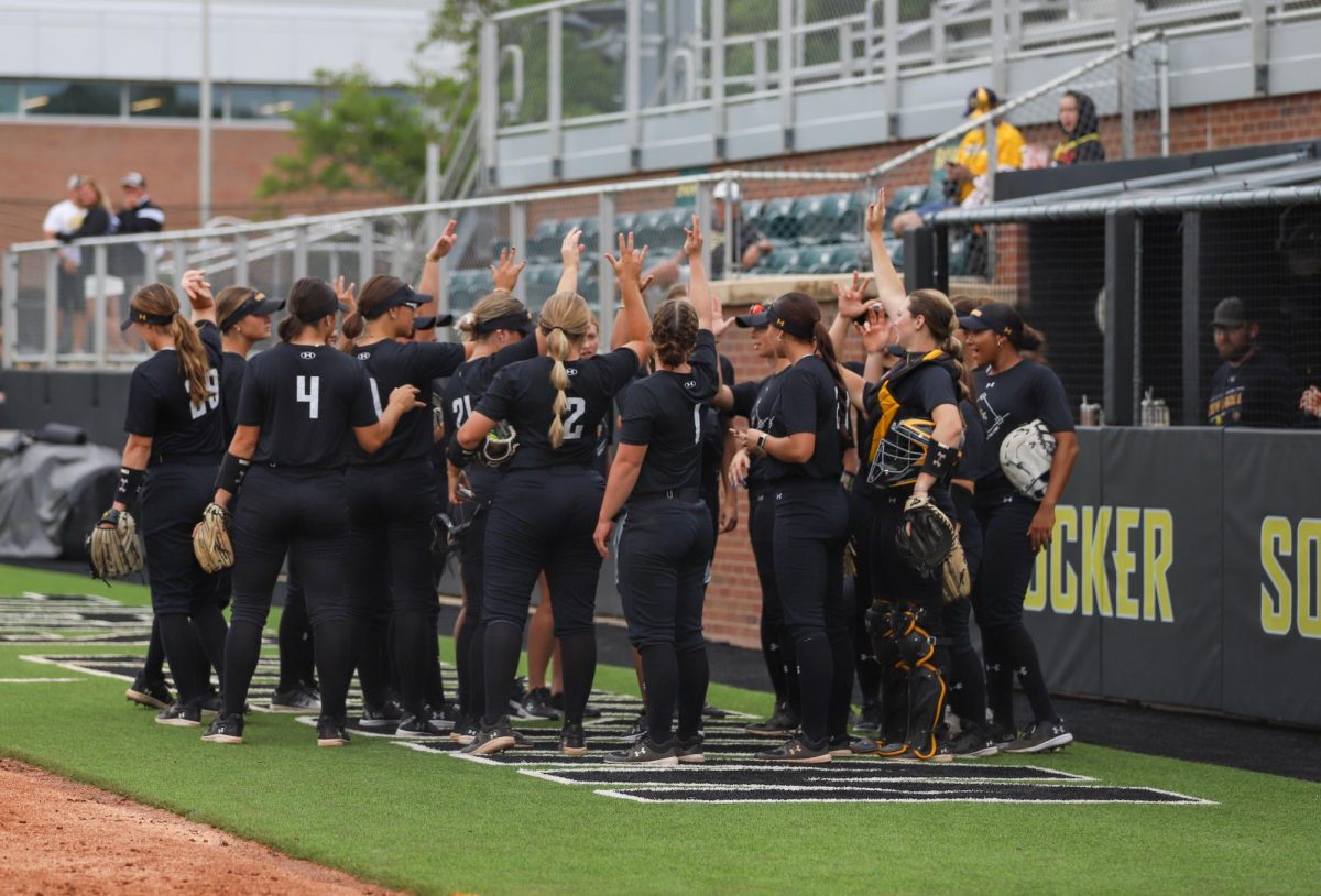 The+Wichita+State+softball+team+gathers+together+before+the+match+against+McLennan+Community+College+on+Sept.+16.