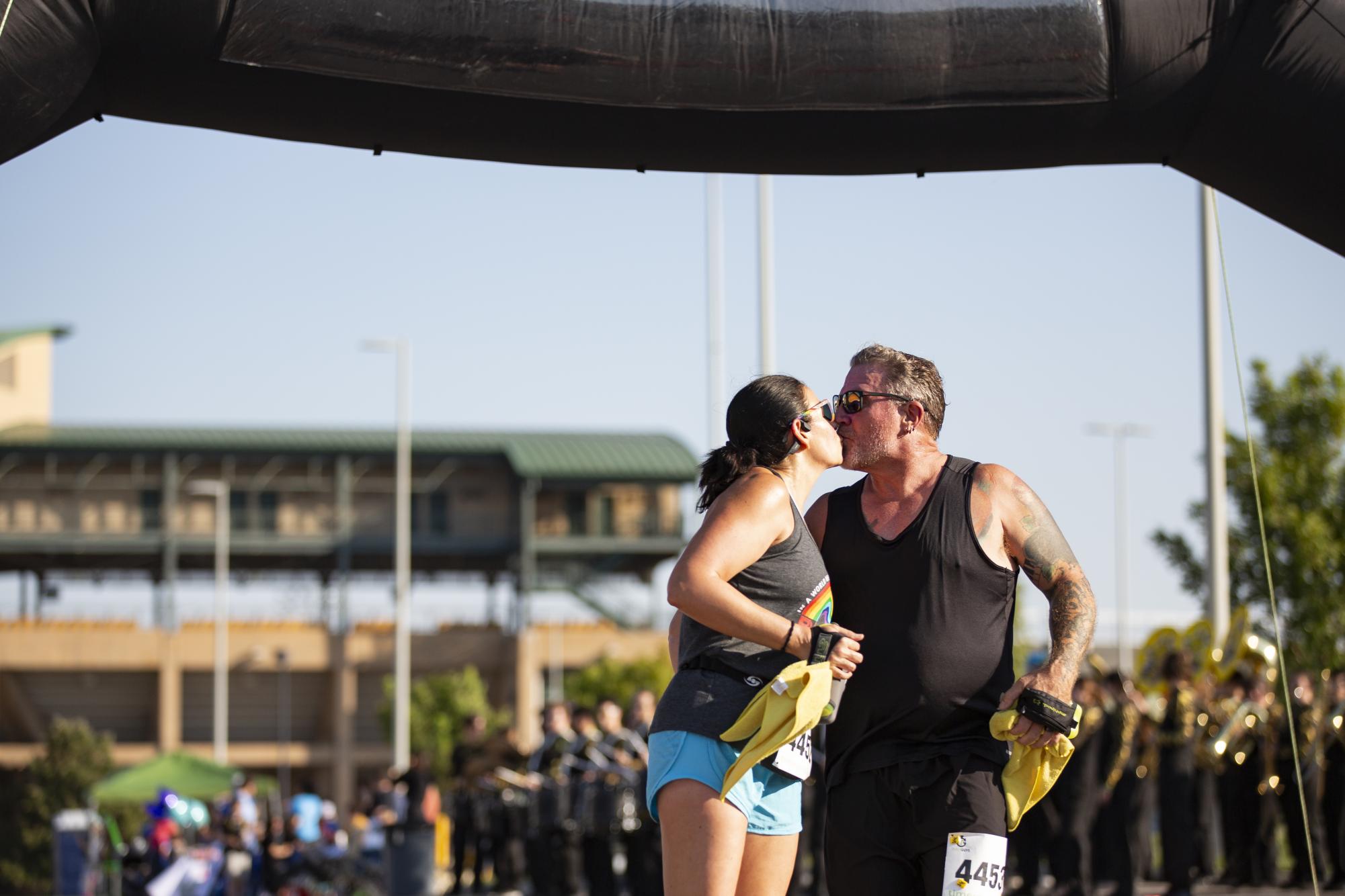 After crossing the finish line together, Kate and Matt Anthony kiss at the Suspenders4Hope 5k. Kate won second place in the womens 40-49-year-old category of the race, while Matt won second in the 50-59-year-old category for the men.