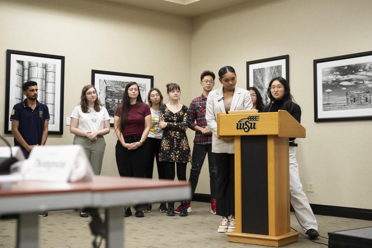 Flanked by members of student organizations, Student Body President Iris Okere and Student Body Treasurer Jia Wen Wang speak to senators at the Sept. 12 meeting about an emergency funding act.