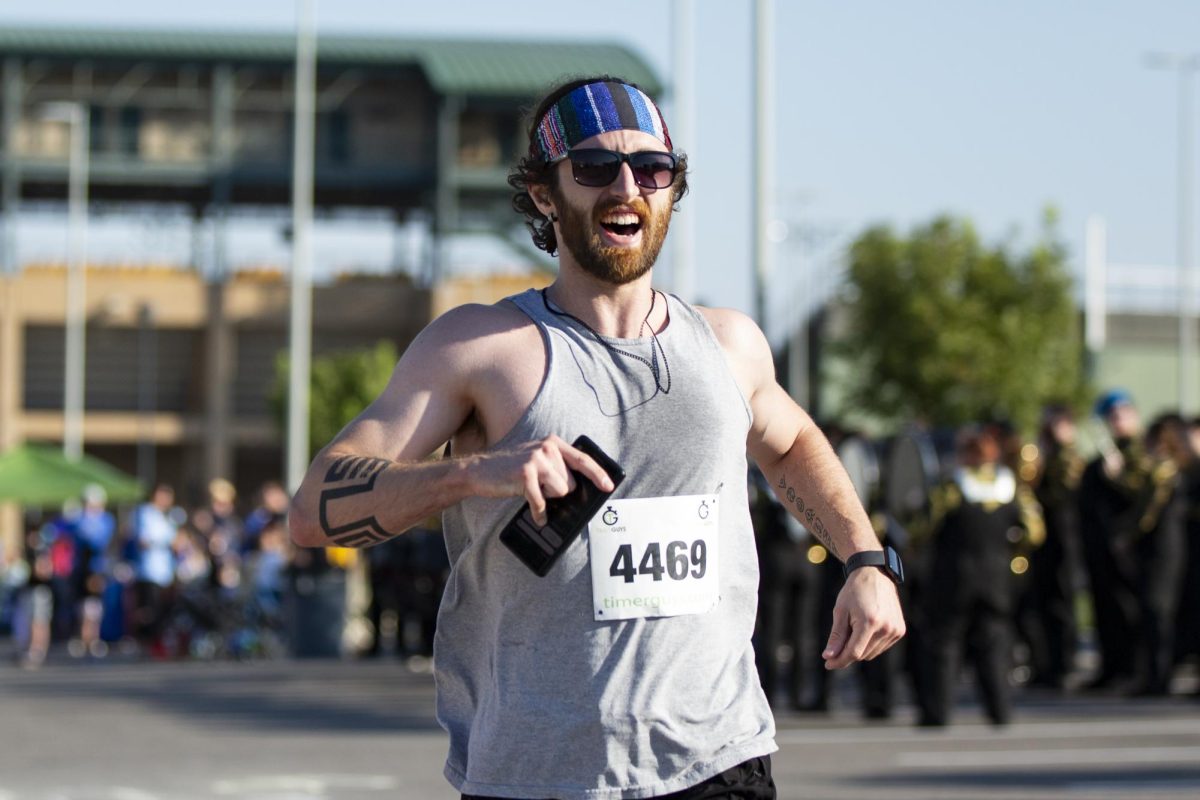 Alec Dulaney, 29, smiles as he crosses the finish line on Sept. 30 at the Suspenders4Hope 5k. 