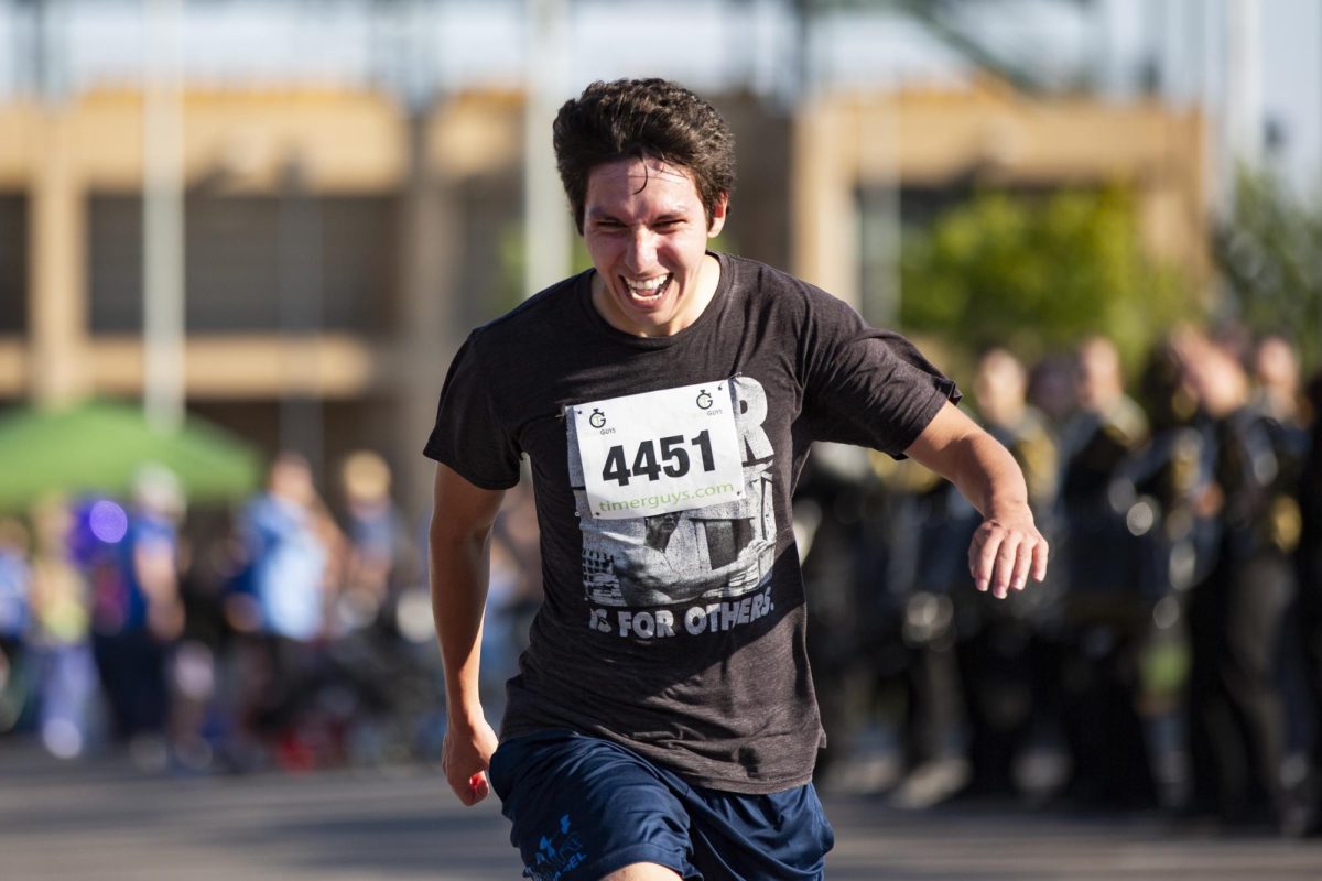 David Albarracin, 26, smiles as he crosses the finish line of the Suspenders4Hope 5k on Sept. 30. 