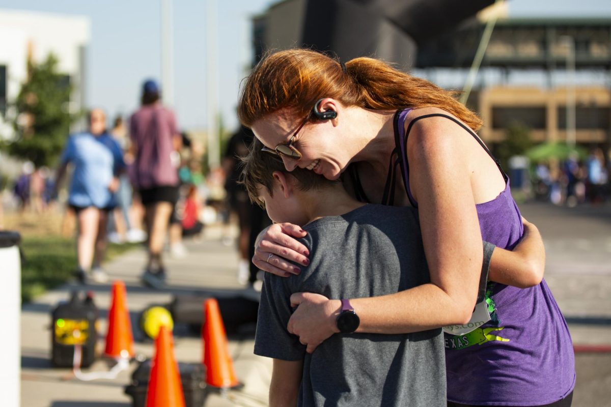 Audra Morgan hugs her 10-year-old son after the pair complete the Suspenders4Hope 5k. Morgan won third place in the races 40-49-year-old, female category.