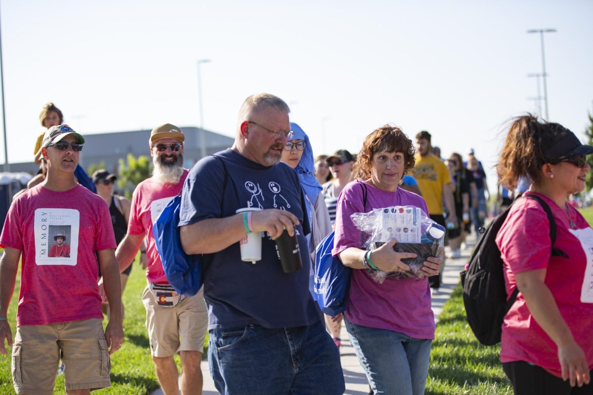 Attendees walk during the Suspenders4Hope one-mile memorial walk on Sept. 30. The one-mile walk followed a 5k.