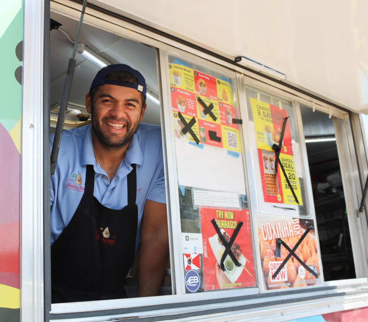 CEO and co-founder Rodrigo Ciriaco pauses to smile while serving authentic Brazilian cuisine at Brazita Bites food truck. Brazita Bites was one of three businesses at SGAS Food Truck Friday on Sept. 8
