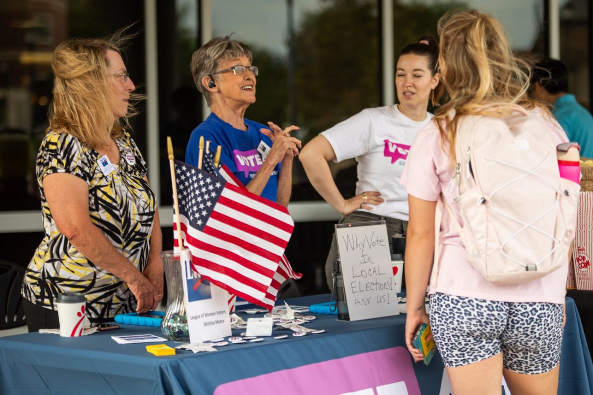 Sandy Wilson, Carole Neal and Kayla Vix from the League of Women Voters talk about registering to vote with junior nursing major Amelia Robertson on National Voter Registration Day, Sept. 19.