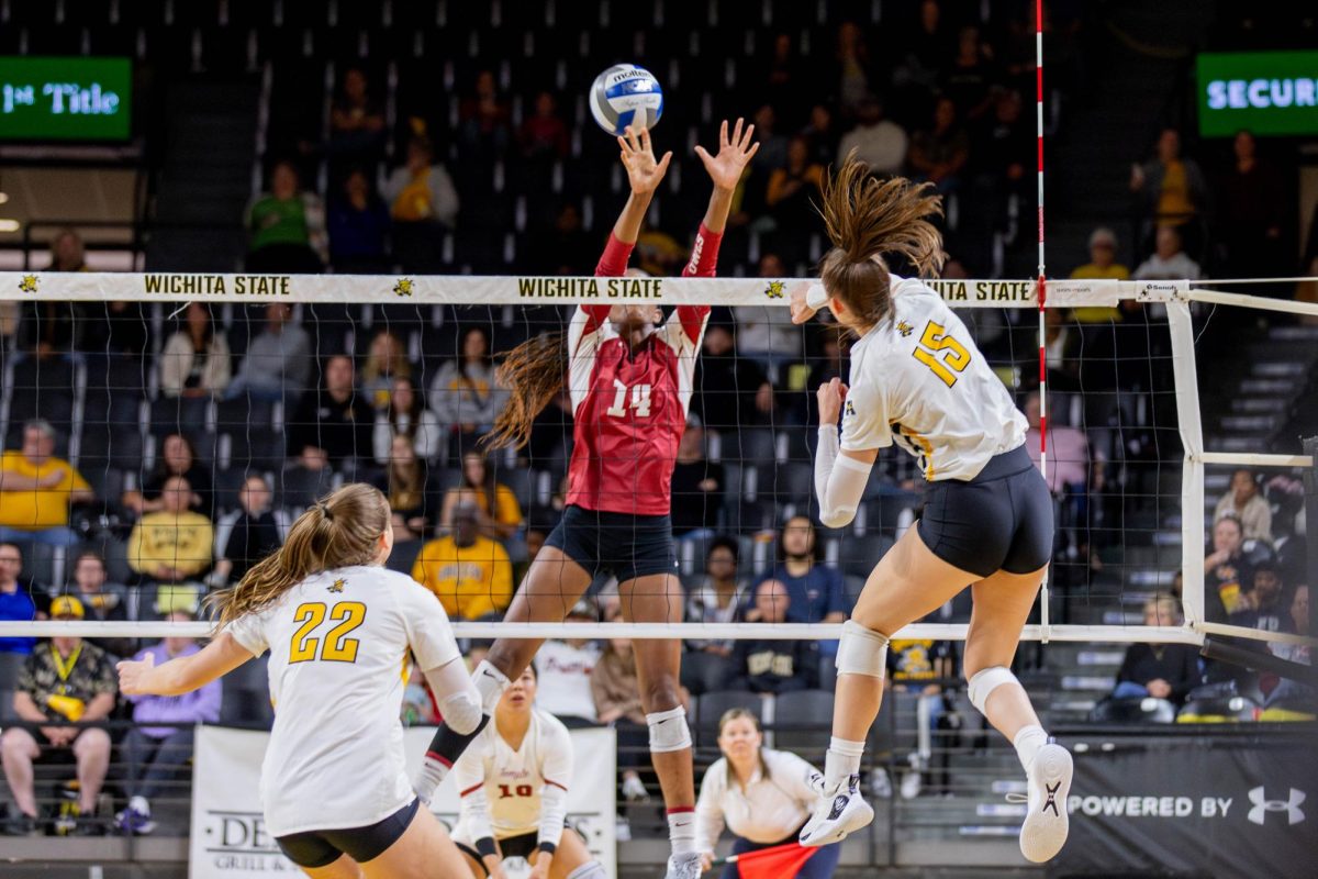 Morgan Weber watches as Morgan Stout hits the ball past an opposing player in the Oct. 6 game in Charles Koch Arena.