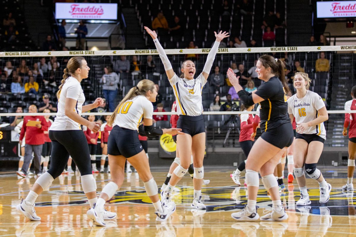 The Wichita State Shockers celebrate after taking a point in the second set. WSU won the first three matches to take the win against Temple on Oct. 6.