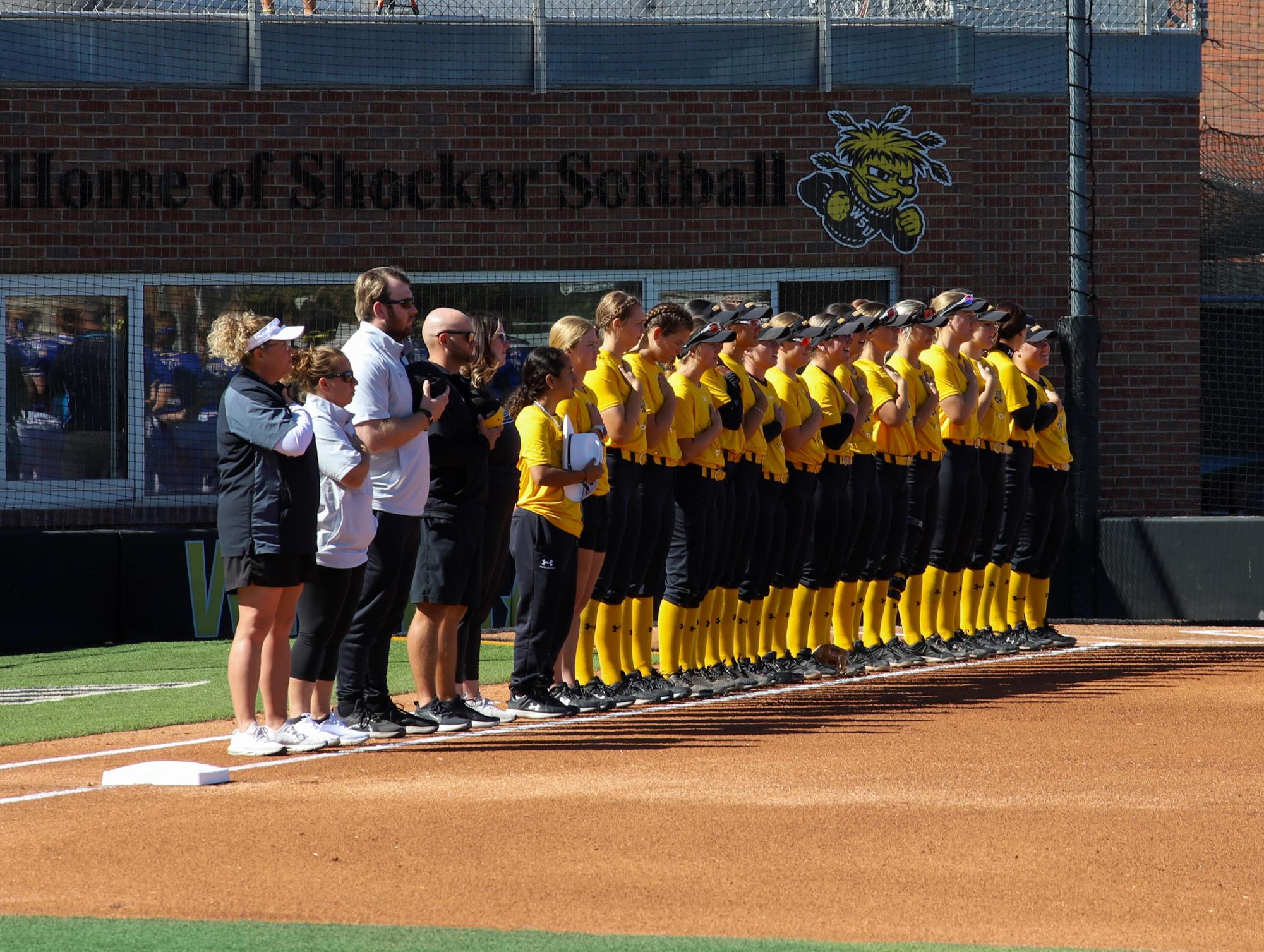 Before the game against South Dakota State on Oct. 8, Wichita State softball players stand in the Pledge of Allegiance.