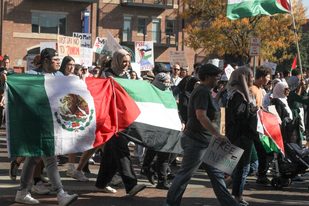 Ricky Dimas and Nope Abdalà walk with connections to the Mexican and Palestinian flags in a show of solidarity. On Oct. 22, a protest was held in support of Palestine at Old Town Square.
