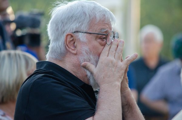 Calvin Herrill rubs tears from his eyes during the memorial ceremony. On Oct. 2, Wichita State held its 53rd annual Memorial 70 service to commemorate the players, faculty and supporters who died in the 1970 plane crash.