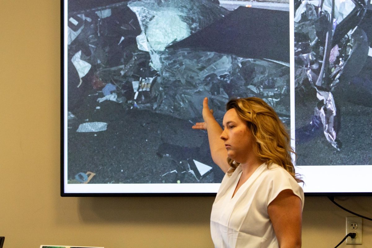 Cheyenne Waller, director of engagement at the DUI Victims Center of Kansas, shows images from her DUI accident. After the accident, Waller said she decided to take control of herself.