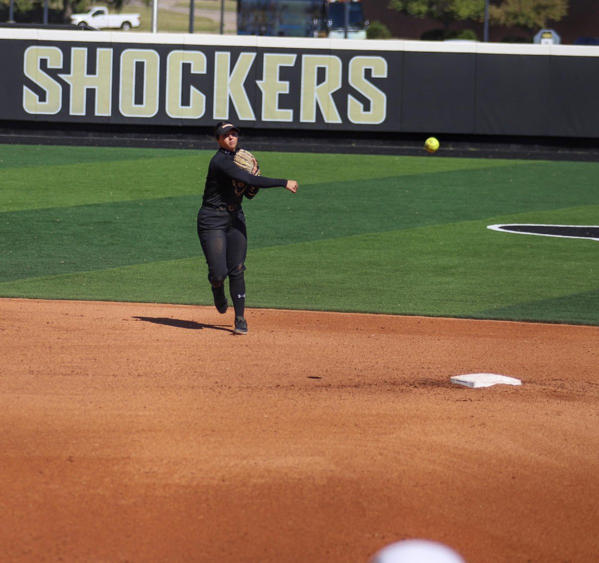 Senior Lauren Lucas throws the ball to first base to get the last out of the inning for Emporia State.