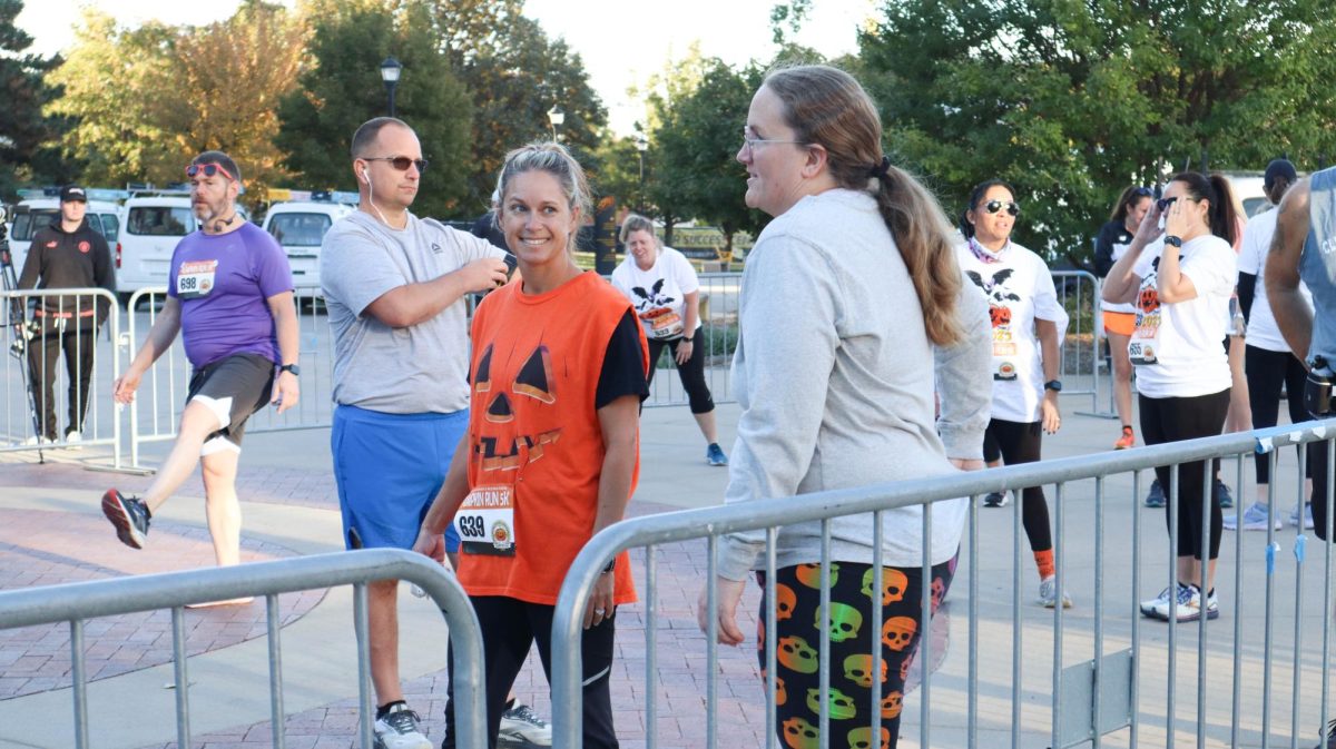 Gabe Walsh and Stephanie Garcia chat before the start of the Pumpkin Run. The Pumpkin Run is an annual 5k hosted at Wichita State.