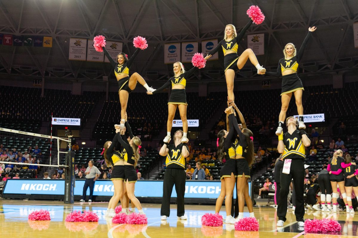 The Wichita State cheer team showcases their skills at the volleyball match against Tulsa on Oct. 20.