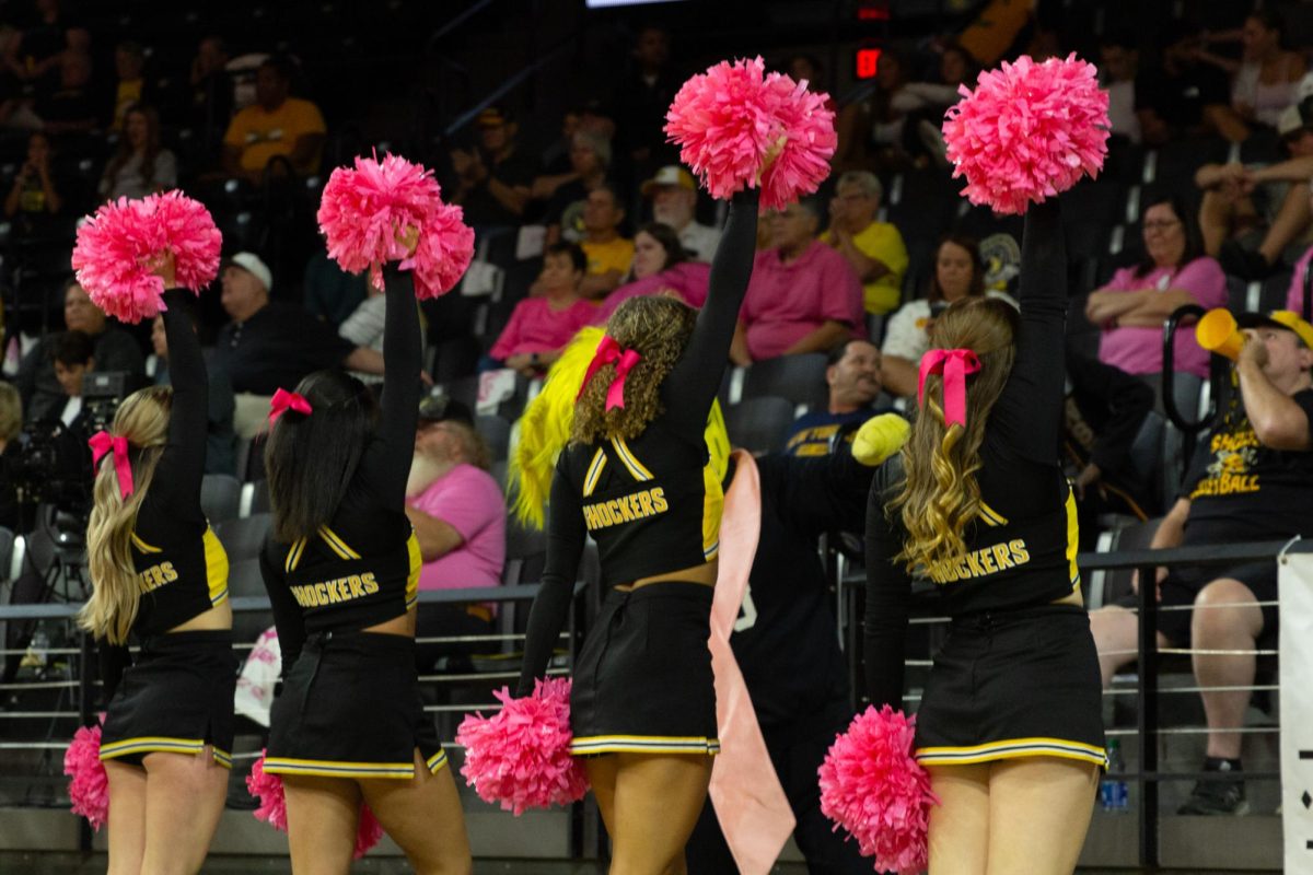 The Wichita State cheer team celebrates the volleyball teams success at the Oct. 20 match. The cheer team performed on the court between sets.