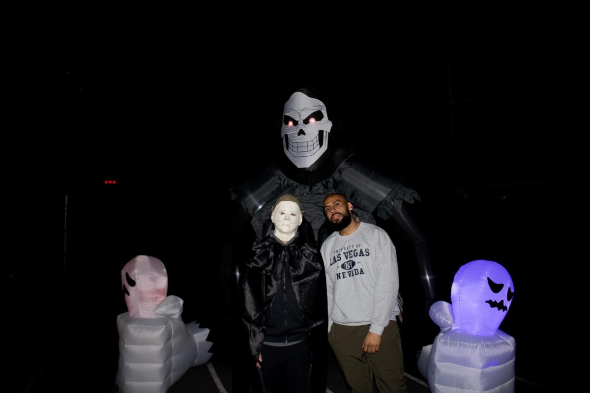 Two of the Heskett Centers workers stand at the entrance to the haunted house before Fright Night begins on Oct. 27.