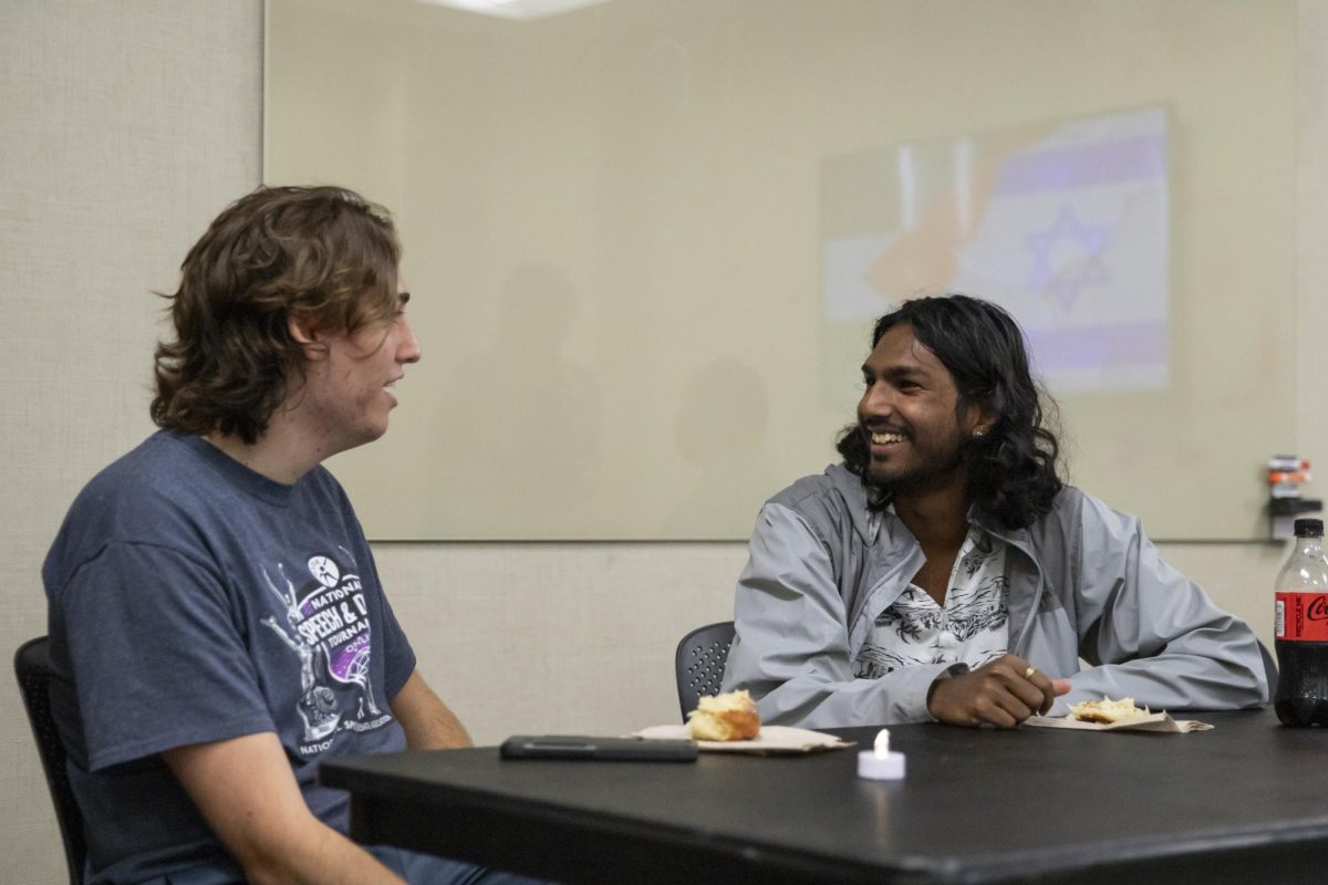 Jewish Student Alliance Vice President and Treasurer Jacob Unruh and Secretary Vishnu Avva speak at the first meeting of the semester on Oct. 24. The first meeting served as a vigil for lives lost in the Israel-Palestine conflict, as well as an intro into the organziation.