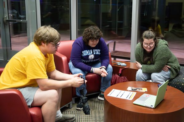 Joe Hanford, marketing officer Carla Cummings, and membership and outreach officer Mia Dennett listen to virtual attendees at the first Disability Rights, Education, Activism and Mentorship meeting on Oct. 25.