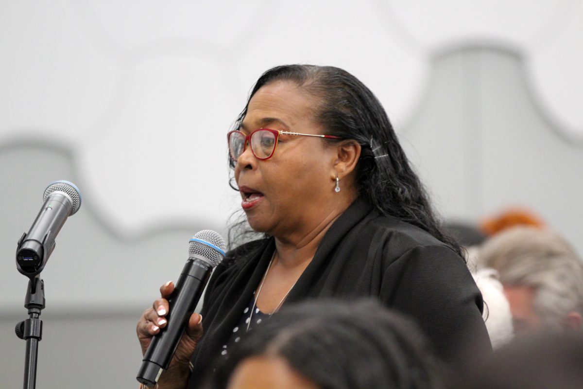 Kansas Senator Oletha Faust-Goudeau asks a question at the community microphone for the mayoral candidates at the mayoral candidate forum. She came from Topeka after attending a meeting on unhoused and poverty-stricken communities.