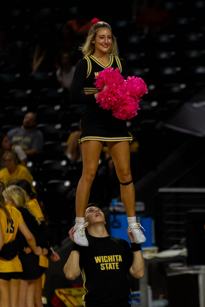 Kale Lowery lifts Isabella Gorges as part of  a stunt routine during a team timeout.