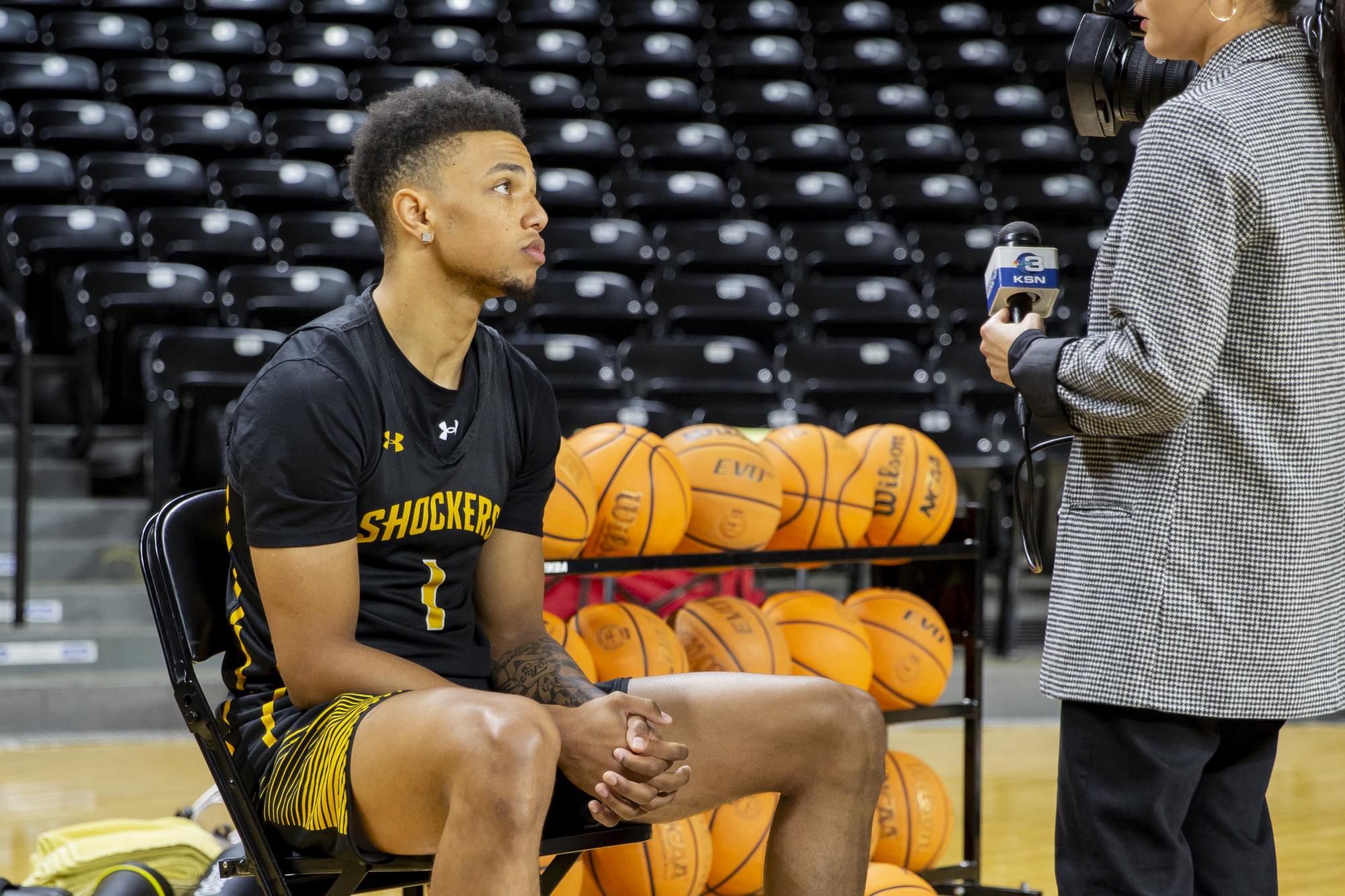 Xavier Bell speaks to a reporter on the 2023-2024 Media Day in Charles Koch Arena. Media Day gave reporters in the Wichita area a chance to speak to womens and mens basketball players.