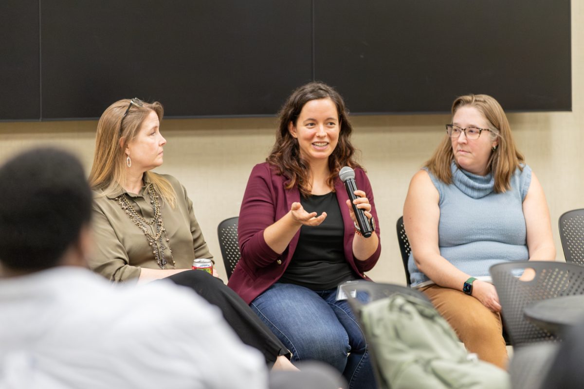 Elizabeth Wingo, director of risk management for Sedgwick County, speaks during the Humanities Panel in the RSC on Oct. 3. Wingo sat between Susan Castro and Robin Henry.