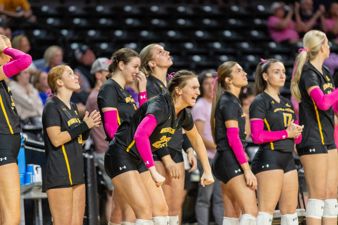 Morgan Weber cheers from the sidelines after the Shockers score a point in the fourth set. Weber scored 14 digs throughout the four sets she played on Oct. 20.