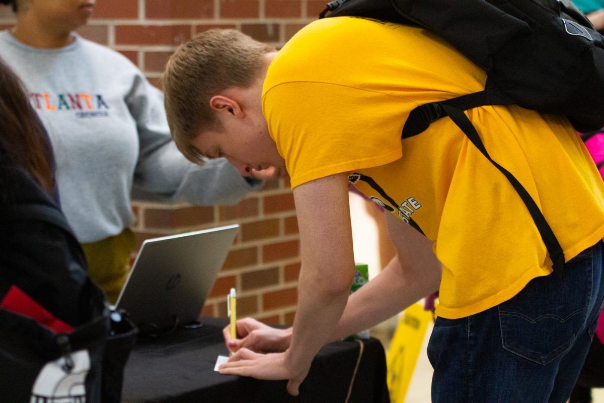 Bryant Eden, an economics major, enters his name in the raffles at the Shockers Vote! Coalition Election Bash in the RSC on Nov. 7.