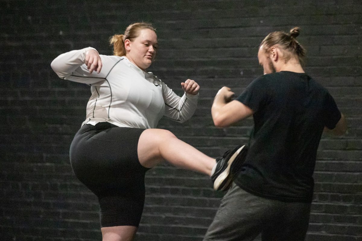 Morgan Holcomb and Zac Richardson, both theatre performance majors, practice stage kicks. The two were involved in a newly formed Fight Club at Wichita State.