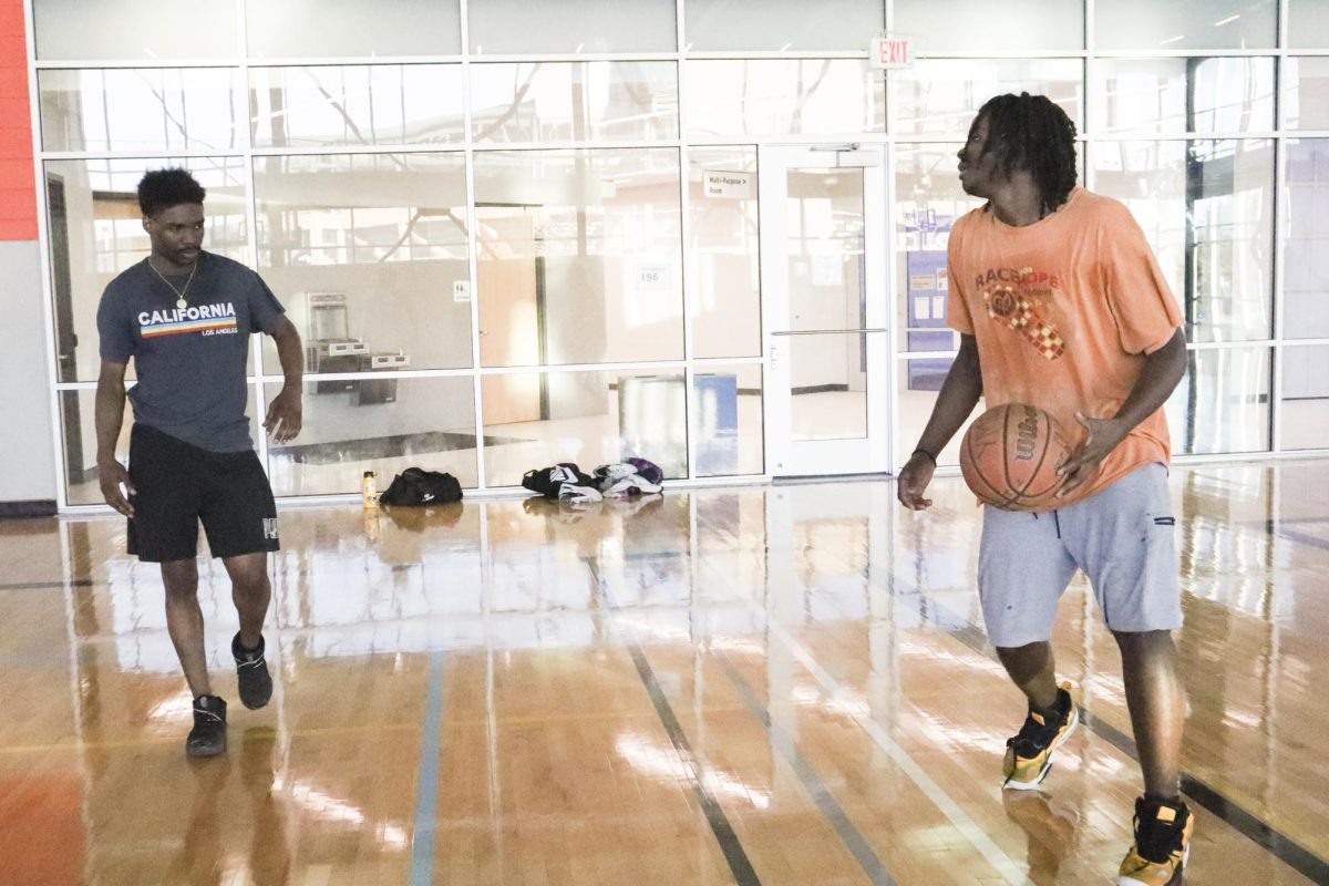 Jamal Brown watches the ball as Lebrian Jones gets ready to make his next move in a casual game of basketball at the Steve Clark YMCA.