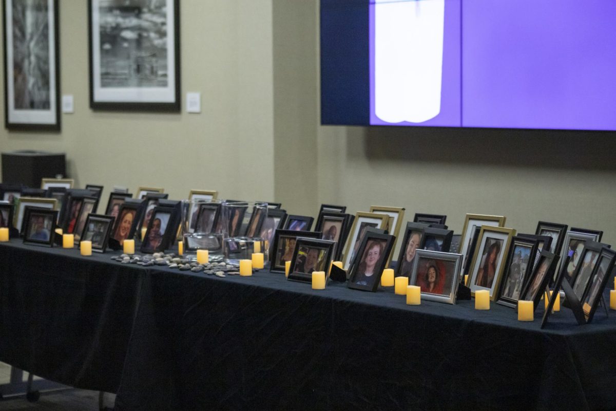 Photos of more than 60 transgender individuals who were killed within the last year in the United States adorn the table at the front of the room. Participants were invited to drop a pebble into a glass jar to honor each lost life.