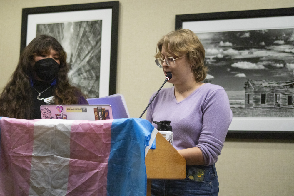 Spectrum: LGBTQ & Allies Vice President Allison Campbell reads the names of more than 60 transgender people who were killed this year. Campbell and Spectrum Treasurer Damaris Mireles took turns reading the names as attendees dropped pebbles into glass jars filled with water.