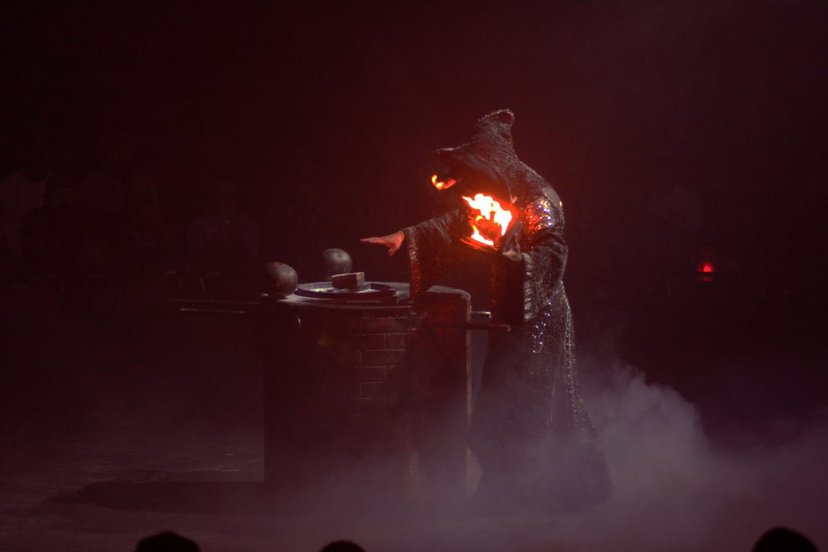 A sorcerer summons a dancer using a spell book caught on fire. The sorcerer appeared in multiple different performances throughout the circus. 