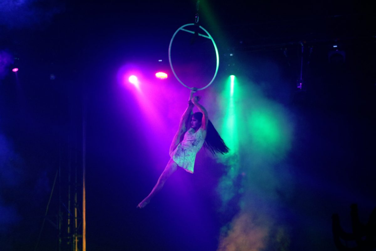 A performer hangs from a ring during the circus performance. She was suspended in air for a bulk of the performance. 
